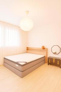 a bedroom with a bed in a room at 숲애스테이 in Hagwanggyo-dong