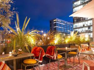 a patio with tables and chairs at night at ibis Marseille Centre Euromed in Marseille