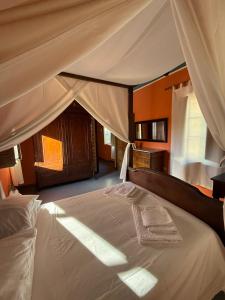 a bedroom with a large bed with a canopy at Antica Dimora in Quartu SantʼElena