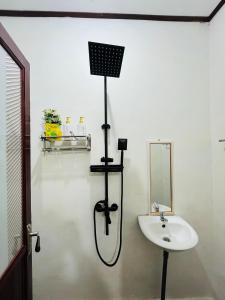 a white bathroom with a sink and a mirror at pinggan box glamping in Bangli
