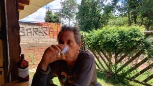 a man drinking a drink from a glass at Casa en Cataratas del Iguazú - GUEST HOUSE - in Puerto Iguazú