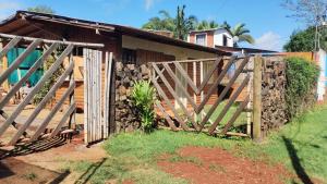 a wooden fence in front of a house at Casa en Cataratas del Iguazú - GUEST HOUSE - in Puerto Iguazú