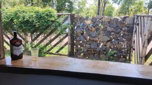 a bottle of wine sitting on a table with a glass at Casa en Cataratas del Iguazú - GUEST HOUSE - in Puerto Iguazú +2 photos