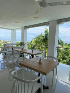 a row of tables and chairs on the balcony of a restaurant at Kainos Tropical Boutique Hotel in Las Terrenas