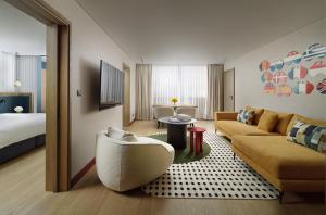 a living room with a couch and a bed at Athenaeum Intercontinental by IHG in Athens