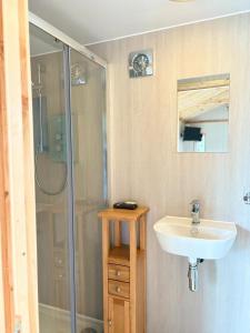 a bathroom with a sink and a shower at Quiet Skye Winter hideaway Moluag in Portree +14 photos