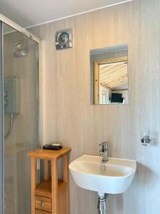 a bathroom with a sink and a mirror at Quiet Skye Winter hideaway Moluag in Portree