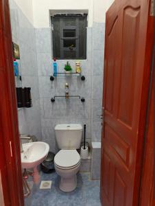 a bathroom with a toilet and a sink at Serene luxe homes in Thika
