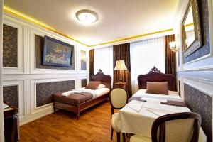 a hotel room with two beds and a couch at Dom Pomorski in Miastko +14 photos