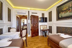 a hotel room with two beds and a television at Dom Pomorski in Miastko