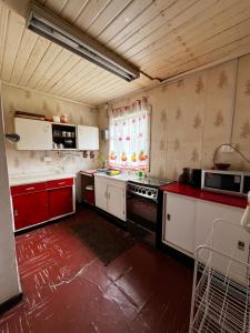 eine Küche mit roten und weißen Geräten in einem Zimmer in der Unterkunft Casa en algarrobo con hermosa vista al mar in Algarrobo + 9 Fotos