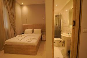 a bedroom with a bed and a sink and a toilet at KASTELLO hotel in Cairo +53 photos