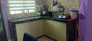a kitchen with a sink and a counter at Homestay kak bee d' bendang in Jitra