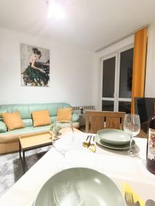 a living room with a couch and a table at Mladost the City of Fountains Vitosha View in Sofia