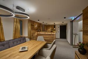 a conference room with a wooden table and chairs at Die Monika Aparthotel in Gaschurn