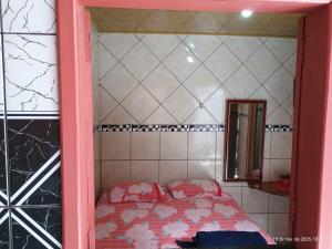 a small bedroom with a bed and a mirror at Point da ilha in Belém +2 photos