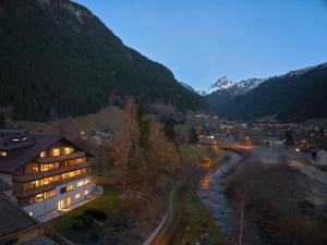 a view of a town with a river and mountains at Die Monika Aparthotel in Gaschurn