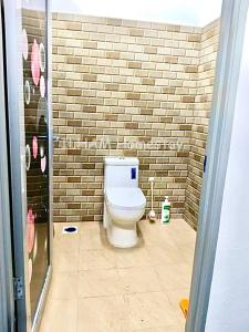 a bathroom with a white toilet in a brick wall at ILHAM homestay in Kota Bharu +5 photos