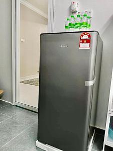 a refrigerator with bottles of water on top of it at ILHAM homestay in Kota Bharu
