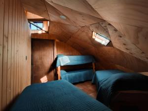 a bedroom with two beds in a attic at Parcela "La Negra", Hermoso para familias y amigos in Bulnes