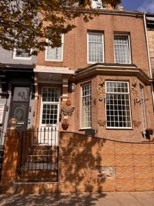 a brick building with a gate in front of it at Croft Guest House in South Shields