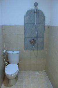 a bathroom with a shower with a toilet in it at Malaka ocean homestay in Kuta Lombok