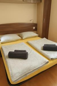 two beds with towels on them in a room at #437 Status Relax Like a Boss in Biograd na Moru