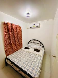 a small bed in a room with a curtain at Balai Camu Fully Furnished Luxury Home in Sampong