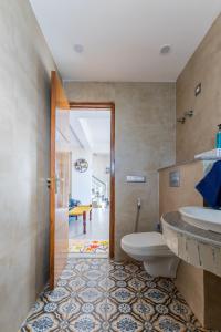 a bathroom with a toilet and a sink at The Sky Penthouse - Mussoorie Rd Da Alohas Retreat in Dehradun