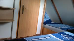 a room with two bunk beds and a door at Ferienwohnungen Goller in Großkoschen