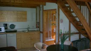 a kitchen with a table and a dining room at Ferienwohnungen Goller in Großkoschen +11 photos