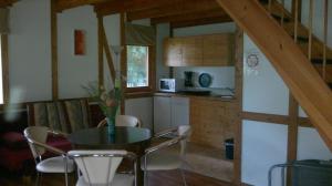 a kitchen with a table and chairs in a room at Ferienwohnungen Goller in Großkoschen