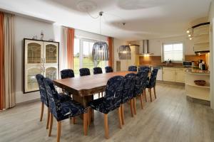 a dining room with a wooden table and chairs at Geräumige Ferienvilla Jenny Am Strand Mit Pool in Klütz +17 photos