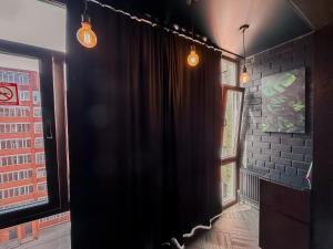 a black curtain in a room with two windows at Люкс в стиле LOFT in Pavlodar