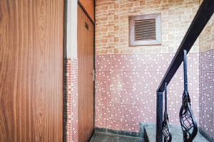 a staircase with a brick wall and a window at Hotel O by OYO Exotica Palace in New Delhi
