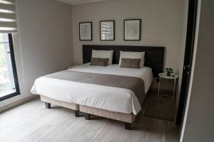 Ένα ή περισσότερα κρεβάτια σε δωμάτιο στο JC Apart Hotel Providencia