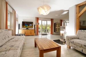 a living room with a couch and a table at Geräumige Ferienvilla Jenny Am Strand Mit Pool in Klütz