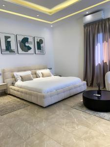 a bedroom with a large bed and a couch at la Villa WOOR Saly Joseph in Mbour +16 photos