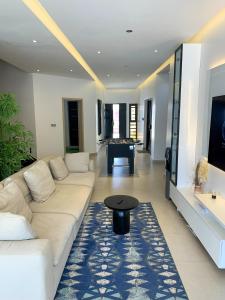 a living room with a white couch and a pool table at la Villa WOOR Saly Joseph in Mbour