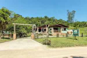a house with a gate in front of a road at Vieira Eco Inn – Deluxe Suite Nilza #1 in Orleans