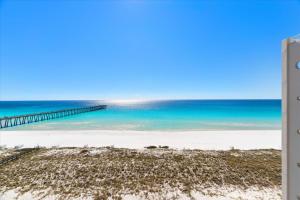 a view of a beach with a pier and the ocean at Sea Esta condo in Navarre