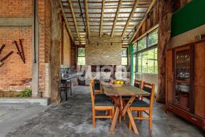 a dining room with a wooden table and chairs at Vieira Eco Inn – Deluxe Suite Vanio #2 in Orleans +12 photos