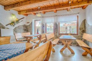a dining room with wooden tables and chairs at Pod Wodospadem in Szczyrk