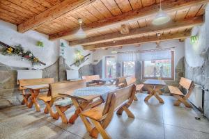 a dining room with wooden tables and chairs at Pod Wodospadem in Szczyrk +35 photos