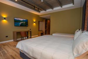 a bedroom with a large white bed and a desk at Porta e Alpeve in Gradec +56 photos