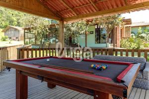 a pool table sitting on a deck with at Vieira Eco Inn – Master Suite Vanderleia in Orleans