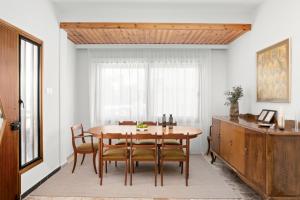 a dining room with a wooden table and chairs at Casa Centrale by Nomads in Paphos City