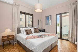 a bedroom with a bed and a large window at Casa Centrale by Nomads in Paphos City