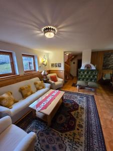 a living room with a couch and a table at Chalet Genziana in Cavalese