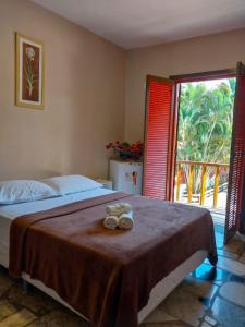a bedroom with a bed with two towels on it at Super Flats Geribá in Búzios +16 photos